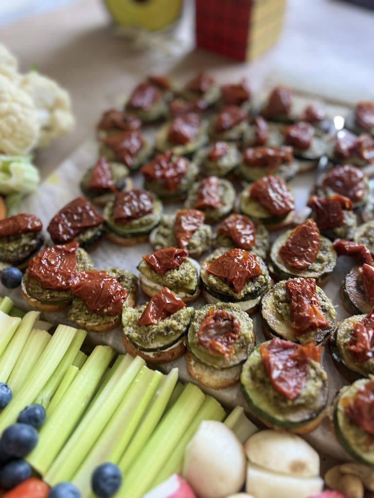 Close-up of gourmet bruschetta topped with pesto and sun-dried tomatoes, perfect for appetizers.